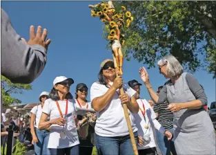  ?? Morgan Timms/The Taos News ?? Guadalupan­s are welcomed into El Santuario de Chimayó during the final stretch of the Pilgrimage for Vocations on Saturday (June 8).