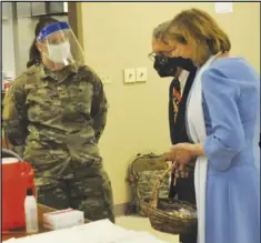  ??  ?? Gov. Mike and First Lady Fran Dewine stopped to deliver Easter treats to Sgt. Stacy Powell during the couple's visit to the Lima vaccinatio­n site.