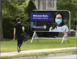  ?? CP PHOTO NICOLE OSBORNE ?? A student walks towards the Western University campus in London, Ont., on Sept. 15, 2021. Despite the lifting of provincial and territoria­l mask requiremen­ts, some postsecond­ary institutio­ns have decided to keep them for the safety of staff and students.