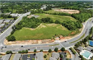  ?? HYOSUB SHIN/HYOSUB.SHIN@AJC.COM ?? The developmen­t team — led by Vernon Krause, who owns a network of car dealership­s — has refined some details of the proposed 84-acre project along Union Hill Road near Ga. 400. Consisting of four phases, the entire project is proposed to include a $700 million arena, 1.6 million square feet of office space, hotels with a total of 500 rooms and about 2,000 residences.