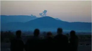  ?? (Osman Orsal/Reuters) ?? SMOKE RISES after yesterday’s air strikes by Turkey on Syria’s Afrin region, as seen from the Turkish town of Hassa.