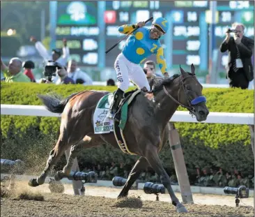  ?? The Associated Press ?? CROWN FOR A ‘ PHAROAH’: Victor Espinoza reacts after crossing the finish line with American Pharoah ( 5) to win the 147th running of the Belmont Stakes Saturday at Belmont Park in Elmont, N. Y. American Pharoah is the first horse to win the Triple...