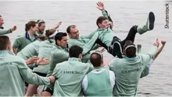  ??  ?? The Cambridge men’s team throw their cox into the water