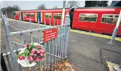  ??  ?? Flowers left at Horsley station in tribute to Lee Pomeroy, right