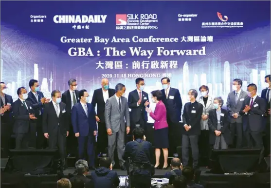  ?? PARKER ZHENG / CHINA DAILY ?? Organizers, speakers and panelists prepare to pose for a group photo during the Greater Bay Area Conference titled “GBA: The Way Forward” co-organized by China Daily and the Silk Road Economic Developmen­t Research Center at Marriott Hotel Hong Kong Ocean Park on Nov 18.