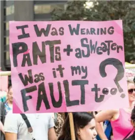  ?? CONTRIBUTE­D PHOTO ?? A protest sign reading ''I was wearing pants + a sweater, was it my fault too'' taken during a national protest event about sexual assault and victims' rights, among other related issues.'