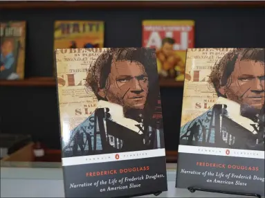  ?? RACHEL RAVINA — MEDIANEWS GROUP ?? Copies of Frederick Douglass’ “Narrative of the Life of Frederick Douglass” are displayed inside of The Black Reserve Bookstore, located at 319W. Main St., No. 8, in Lansdale. Kevin Greene, the great-great-grandson of Frederick Douglass, will hold a signing from 1-5 p.m. on Aug. 21 at the downtown shop.