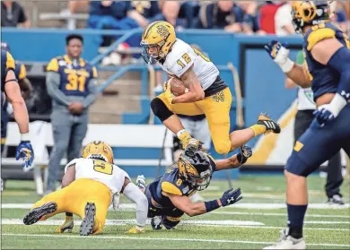  ?? Kennesaw State - Kyle Hess ?? Kennesaw State running back Isaac Foster leaps over Kent State safety Elvis Hines in 2019. Foster, a Chattooga High School graduate, was voted Thursday as the Big South Conference’s preseason offensive player of the year.