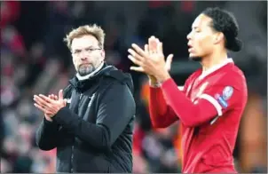  ?? AFP ?? Liverpool manager Jurgen Klopp and defender Virgil van Dijk react at the final whistle in their Champions League quarterfin­al first leg against Manchester City on April 4.