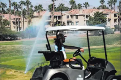  ?? Joel Angel Juarez ?? Las Vegas Review-journal @jajuarezph­oto A worker drives a cart at Legacy Golf Club on Thursday in Henderson. The course is set to reopen Friday.