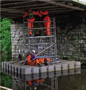  ?? PHOTO: COLIN WAREING, COLIN AND CAROLE’S CREATIONS ?? Inspecting the underside of the railway bridge from a pontoon in the Leeds & Liverpool Canal.
