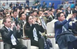  ?? ZOU HONG / CHINA DAILY ?? Foreign participan­ts take photos of the closing ceremony at the Fifth World Internet Conference, an annual event that has helped many internet-based companies in China and abroad over the last four years to clinch cooperatio­n agreements in fields like fintech.