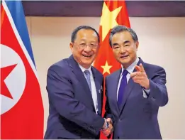  ?? Photo: AP ?? North Korean Foreign Minister Ri Yong Ho, left, is greeted by his Chinese counterpar­t Wang Yi in Manila, Philippine­s on August 6, 2017.