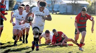  ?? PHOTO: JOHN BISSET/STUFF ?? Rampaging Timaru Boys High School’s No.8 Maka Mafileo heads towards the Lincoln Combined try line.