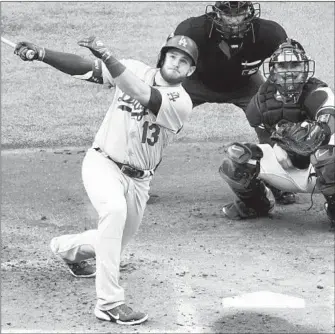  ?? SUE OGROCKI/AP ?? Max Muncy hits a grand slam as part of the Dodgers’ 11-run first inning during Wednesday night’s victory.