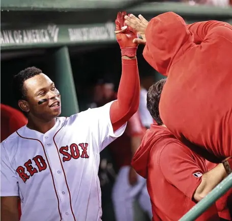  ?? MATT STONE / BOSTON HERALD ?? HE’S ON FIRE Rafael Devers, who drove in three runs, celebrates his solo homer in the third inning of the Red Sox’ 5-3 victory against the Toronto Blue Jays last night at Fenway Park.