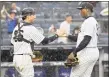  ?? Bill Kostroun / Associated Press ?? Aroldis Chapman, right, and catcher Kyle Higashioka celebrate after the Yankees win over the Rangers on Saturday.