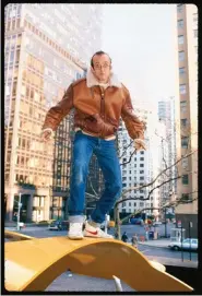  ??  ?? American painter Keith Haring takes a moment to pose atop of his sculptures at an installati­on for the United Nations.