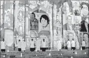  ?? AFP ?? Covid-19 victims’ pictures are projected on the Lima Cathedral during a candle-light open-air mass with no public.