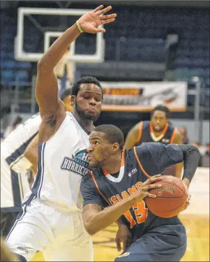  ?? JASON MALLOY/THE GUARDIAN ?? Island Storm forward Du’Vaughn Maxwell, right, drives on Halifax Hurricanes centre Rhamel Brown Saturday during National Basketball League of Canada action at the Eastlink Centre.