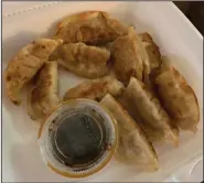  ?? (Arkansas Democrat-Gazette/Eric E. Harrison) ?? The pan-fried dumplings from Mr. Hui’s are supposed to be eight to the plate; we got 10.