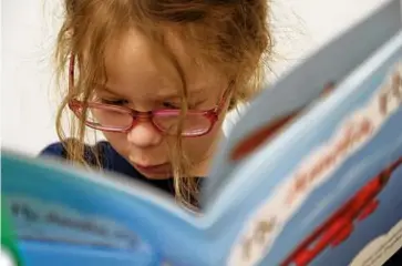  ?? SUZANNE KREITER/GLOBE STAFF ?? At the Dr. Thomas J. Curran Early Childhood Education Center, Jessie Barton worked on reading in her kindergart­en class.