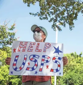  ?? BRONTE WITTPENN/USA TODAY NETWORK ?? Sarah Lyford expresses her support for the U.S. Postal Service during a rally Tuesday in front of a post office in Austin, Texas. Some fear postal cutbacks could interfere with elections.
