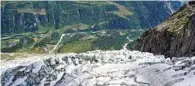  ??  ?? A picture taken from a helicopter shows the Planpincie­ux glacier of the Grandes Jorasses, on the Italian side of the Mont Blanc massif, with the Courmayeur village in the background, Val Ferret, northweste­rn Italy. — AFP