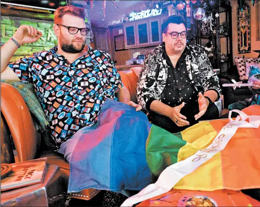  ?? KYLE TELECHAN/POST-TRIBUNE ?? Hobart resident Jared Riddle, right, and his partner Mitch Frey talk about their participat­ion in Pride events on June 21.