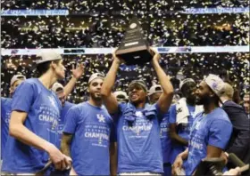  ?? SANFORD MYERS — THE ASSOCIATED PRESS ?? Kentucky players celebrate after beating Arkansas in an NCAA college basketball game for the championsh­ip of the Southeaste­rn Conference tournament Sunday in Nashville, Tenn. Kentucky won 82-65.