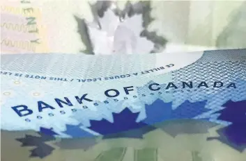  ?? ADRIAN WYLD/ THE CANADIAN PRESS ?? Canadian bank notes are seen on Thursday in Ottawa. The Bank of Canada is once again raising its benchmark interest rate as it sees the economy’s powerful performanc­e pointing to broader, more self-sustaining growth.