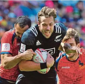  ?? EPA PIC ?? Tim Mikkelson (centre) of New Zealand is held back by Ignacio Martin of Spain on Saturday.