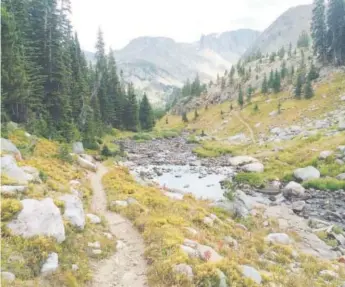  ?? Photos by Mike Eckel, The Associated Press ?? The Beaten Path, a 26-mile hiking trail that crosses throughmon­tana’s Absaroka-beartooth Wilderness, is seen against the backdrop of the wilderness high peaks, some of the most dramatic and beautiful in the entire state.