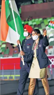  ?? GETTY IMAGES ?? Team India’s flag bearers Mary Kom and Manpreet Singh holding the tricolour during the Opening Ceremony of the Tokyo 2020 Olympic Games on Friday.