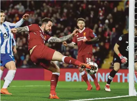  ?? REUTERS PIC ?? Liverpool’s Danny Ings takes a shot at goal in Champions League last 16 2nd leg match at Anfield on Tuesday.