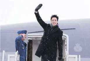  ?? PAUL CHIASSON / THE CANADIAN PRESS ?? Prime Minister Justin Trudeau waves from the steps of his plane as he leaves the nation’s capital for Davos, Switzerlan­d, on Monday.