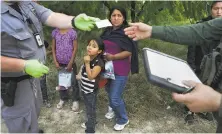  ?? Bob Owen / San Antonio Express-News 2015 ?? President Trump wants to end safeguards for unaccompan­ied minors like this girl detained at the Texas border in 2015.