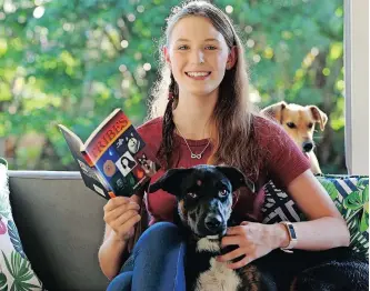  ?? African News Agency (ANA) | SHELLEY KJONSTAD ?? AUTHOR of Tribes, Emily Briggeman, 13, relaxes at her Durban North home with pets Roxy (front) and Chanel (back).