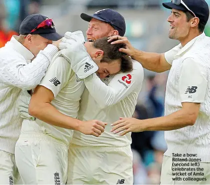  ??  ?? Take a bow: Roland-Jones (second left) celebrates the wicket of Amla with colleagues