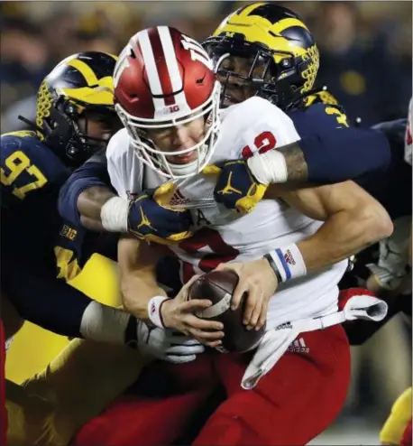  ?? PAUL SANCYA — THE ASSOCIATED PRESS ?? Indiana quarterbac­k Peyton Ramsey (12) is sacked by Michigan defensive lineman Rashan Gary (3) on Saturday.