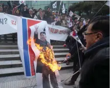  ??  ?? South Korean protesters burn a portrait of North Korean leader Kim Jong-un during a rally against a visit of North Korean Hyon Song Wol, head of a North Korean art troupe