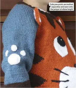  ??  ?? Cute paw prints are knitted separately and sewn onto the jumper at elbow height