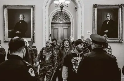  ?? Erin Schaff / New York Times ?? Far-right rioters confront Capitol Police officers near the U.S. Senate chamber on Jan. 6. Trump’s focus on antifa diverted key portions of the federal law enforcemen­t and domestic security agencies at a time when the threat from the far-right was building.