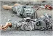  ??  ?? The body of a militant, wearing a military uniform, after the interior ministry attack