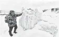  ?? ?? Kaldanov inspects the artificial glacier in a mountain gorge near the village of Syn-Tash.