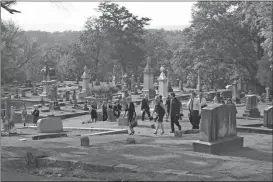  ?? File / Rome News-Tribune ?? Extras walk up Myrtle Hill for a funeral scene on the set of “Need for Speed” in 2013.