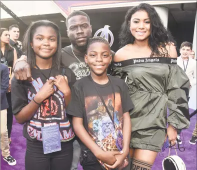  ?? Alberto E. Rodriguez / Getty Images for Disney ?? Kevin Hart and his family attend the Los Angeles World Premiere of Marvel Studios’ “Avengers: Endgame” at the Los Angeles Convention Center on last week in Los Angeles. Hart came under fire for making anti-gay jokes about breaking a dollhouse over his son’s head for playing with his daughter’s toys. Below, ‘City Girls’ rapper Yung Miami who tweeted about beating her son should she see anything gay in him.