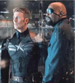  ?? MARVEL ?? Cap (Chris Evans) and Nick Fury (Samuel L. Jackson) are at the center of a big ol’ conspiracy in “Captain America: The Winter Soldier,” the best of the MCU.