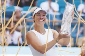  ?? LYNNE SLADKY/AP ?? DANIELLE COLLINS holds her trophy after defeating Elena Rybakina, of Kazakhstan, in the women’s singles final of the Miami Open tournament on Saturday in Miami Gardens, Fla.