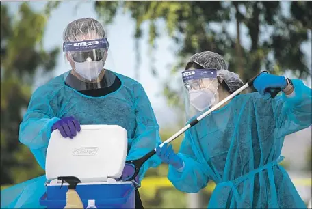  ?? Allen J. Schaben Los Angeles Times ?? ORANGE County, whose virus rates have fallen, is cleared to reopen campuses closed by the pandemic. Above, medical personnel in Irvine.